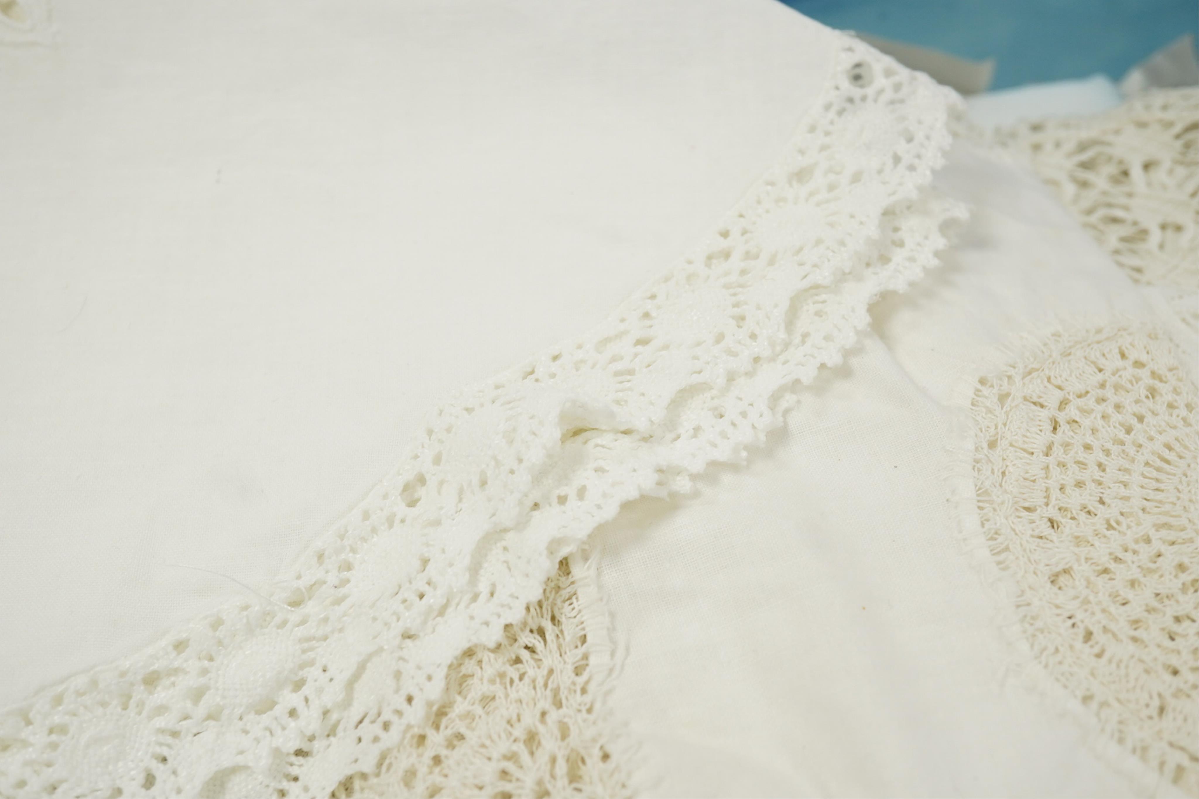 A collection of early 20th century and later crochet, cut work and drawn thread table linens and a large embroidered table cloth